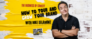 Mike Delamont standing in front of white brick wall with yellow paint and text "The Business of Comedy: How to Tour and Grow Your Brand"