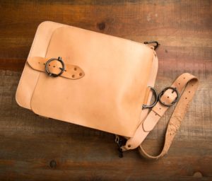 leather satchel on wood floor