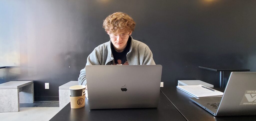 Colten working at laptop