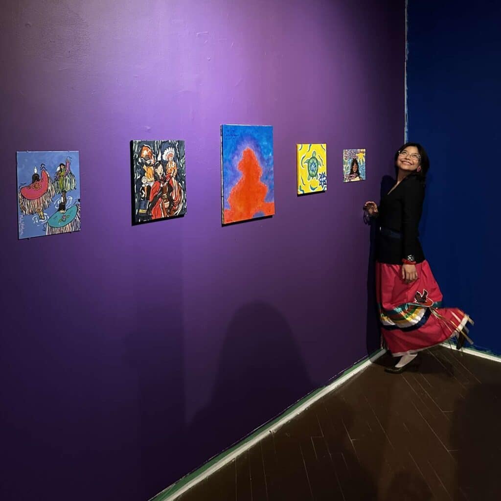 Woman standing in art gallery with purple walls