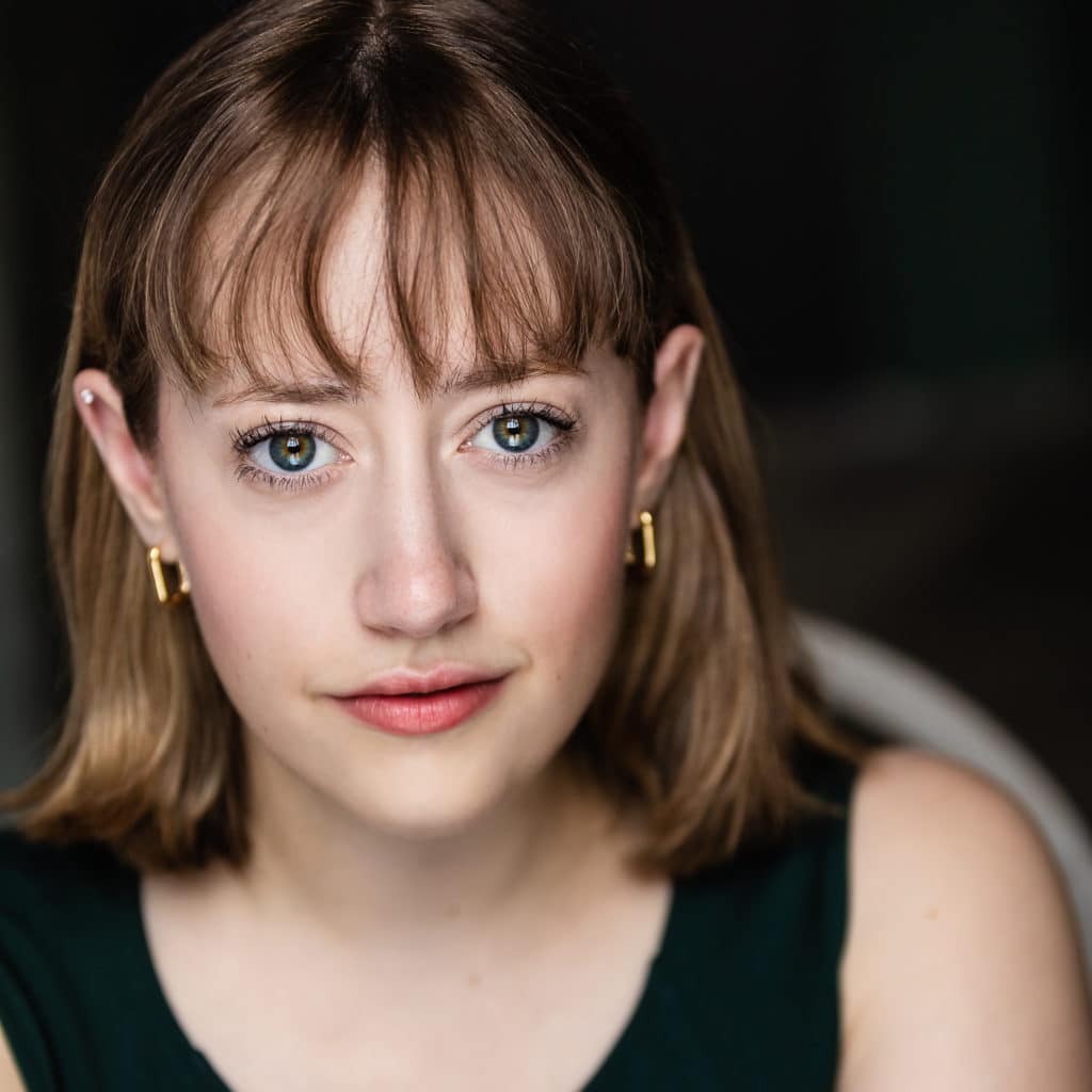 front facing photo of woman with blue eyes and reddish brown hair