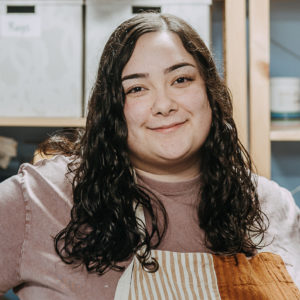 Solange in pottery studio wearing apron