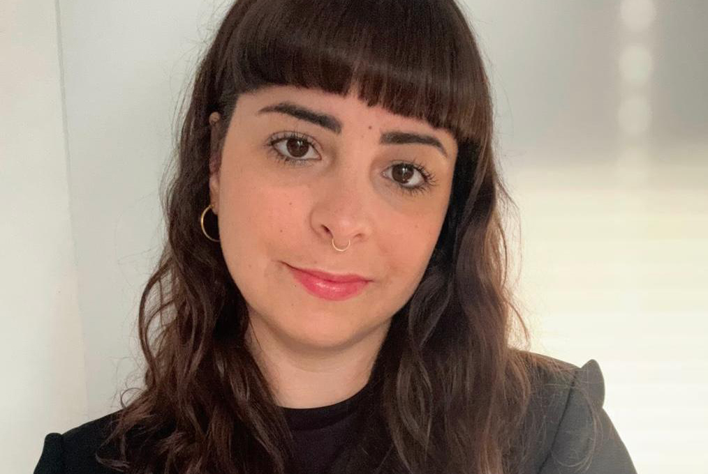 Woman with dark hair and bangs facing camera