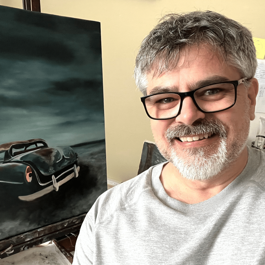man standing in front of painting with old car