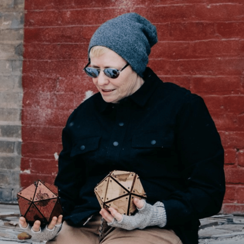 Photo of person with toque and sunglasses looking down
