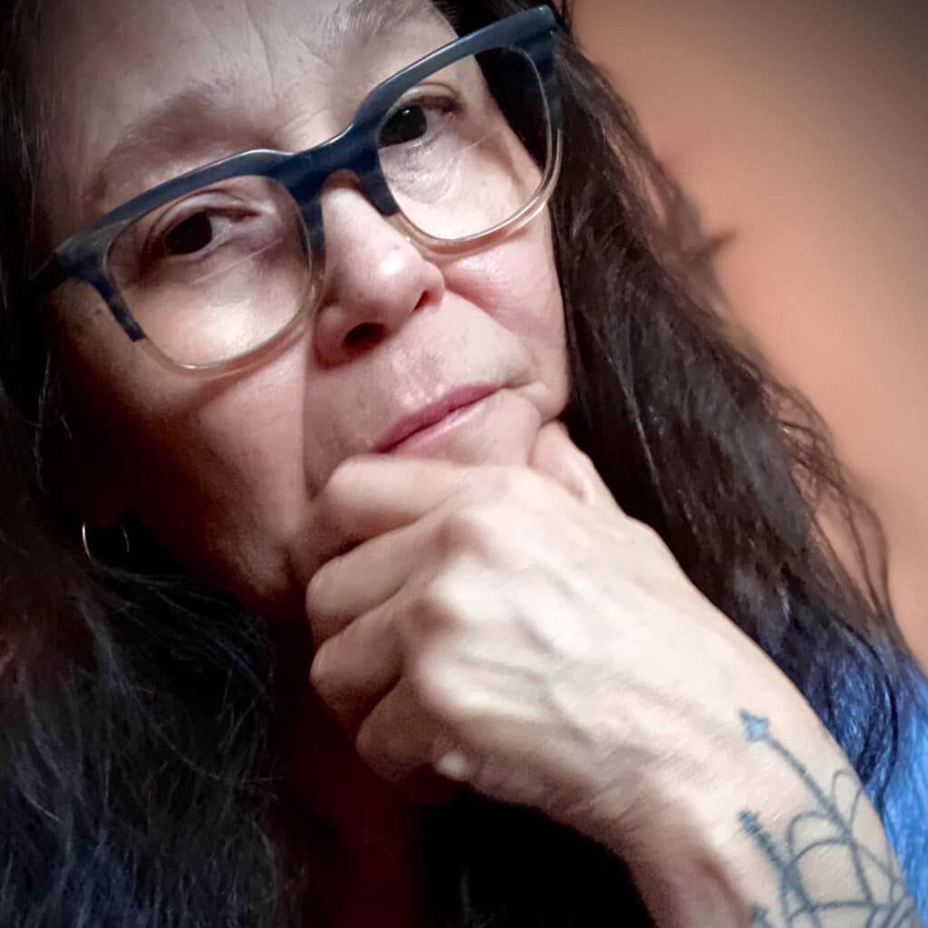 Photo of woman with hand on chin