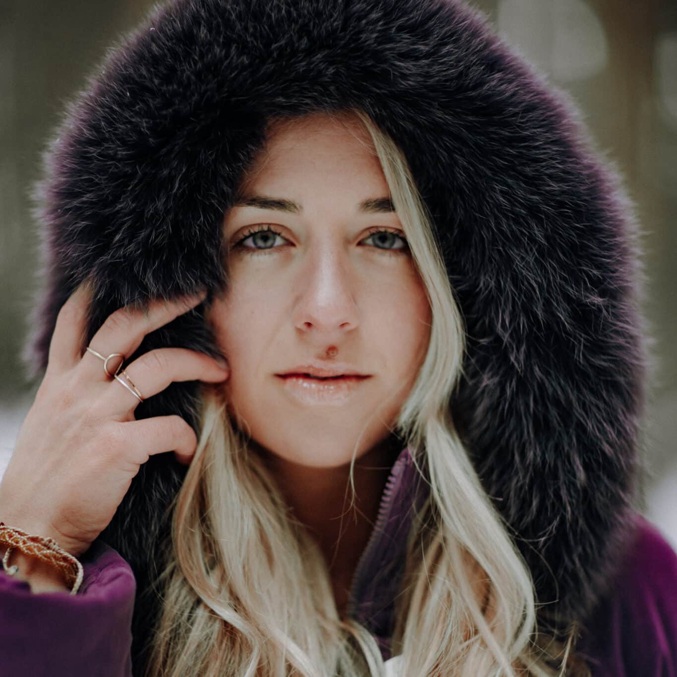 Woman with long blonde hair and fur hood