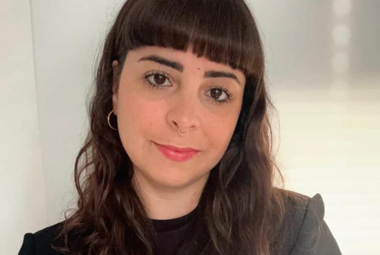 Photo of woman with dark hair and bangs facing camera